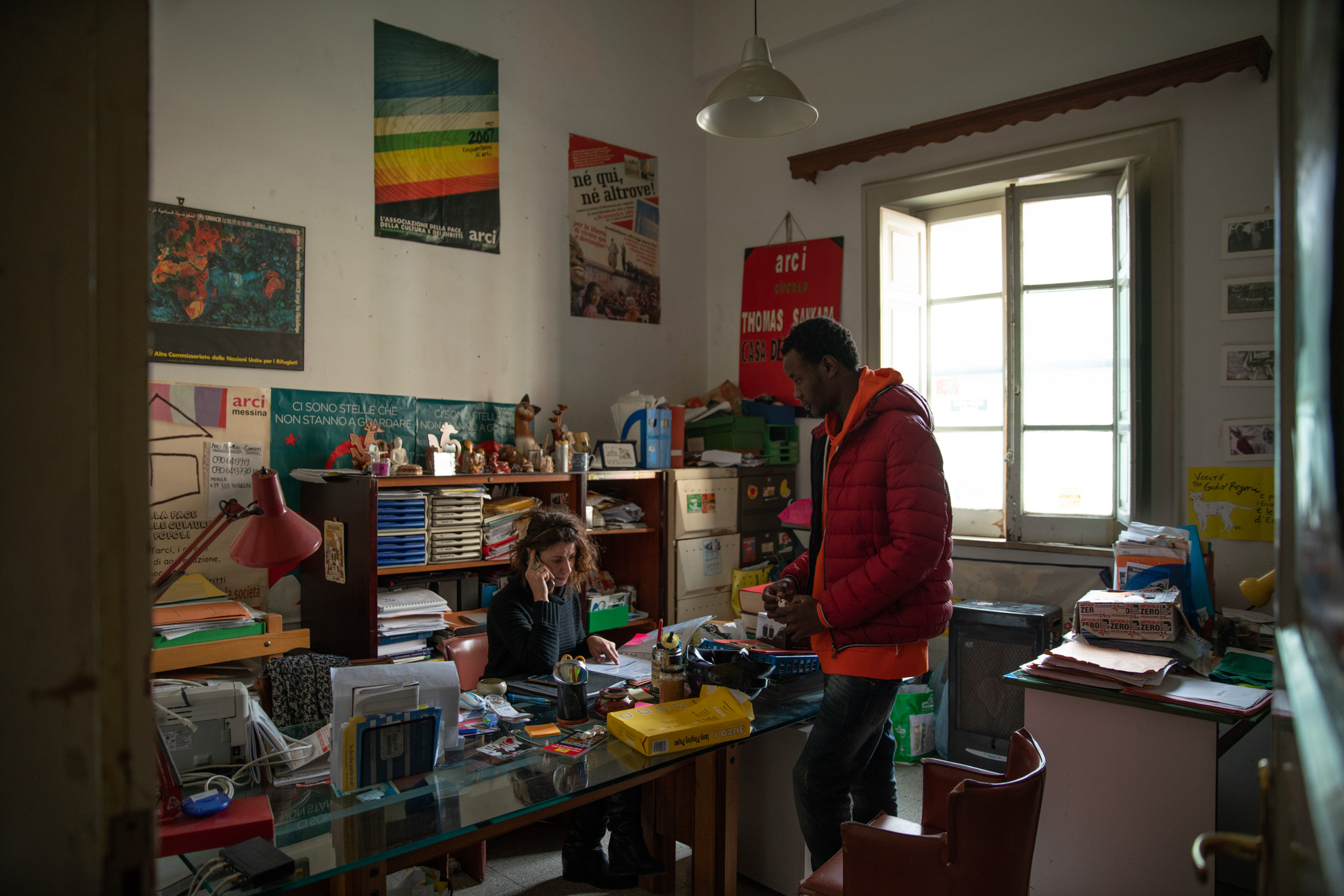 Fidèle discusses the week’s activities with Elena, an Italian teacher and volunteer, at the ARCI Thomas Sankara offices in Messina, Sicily.<br />
<br />
<br />
