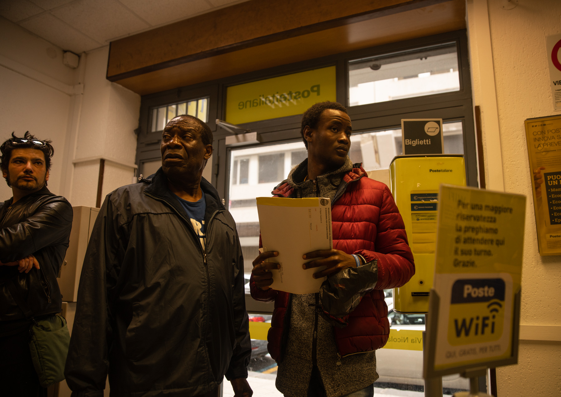 Fidèle assists Marc (61), from Nigeria, at a local post office to forward the renewal application for his temporary residency to Rome. <br />
<br />
However, thousands of migrants see their asylum or immigration applications rejected every year, leaving them without any opportunities for integration, legal work or education.  As a result, Europe has seen a growing shadow population of migrants, undocumented and often stateless, who have no choice but to accept exploitative and illegal working conditions in order to survive. 