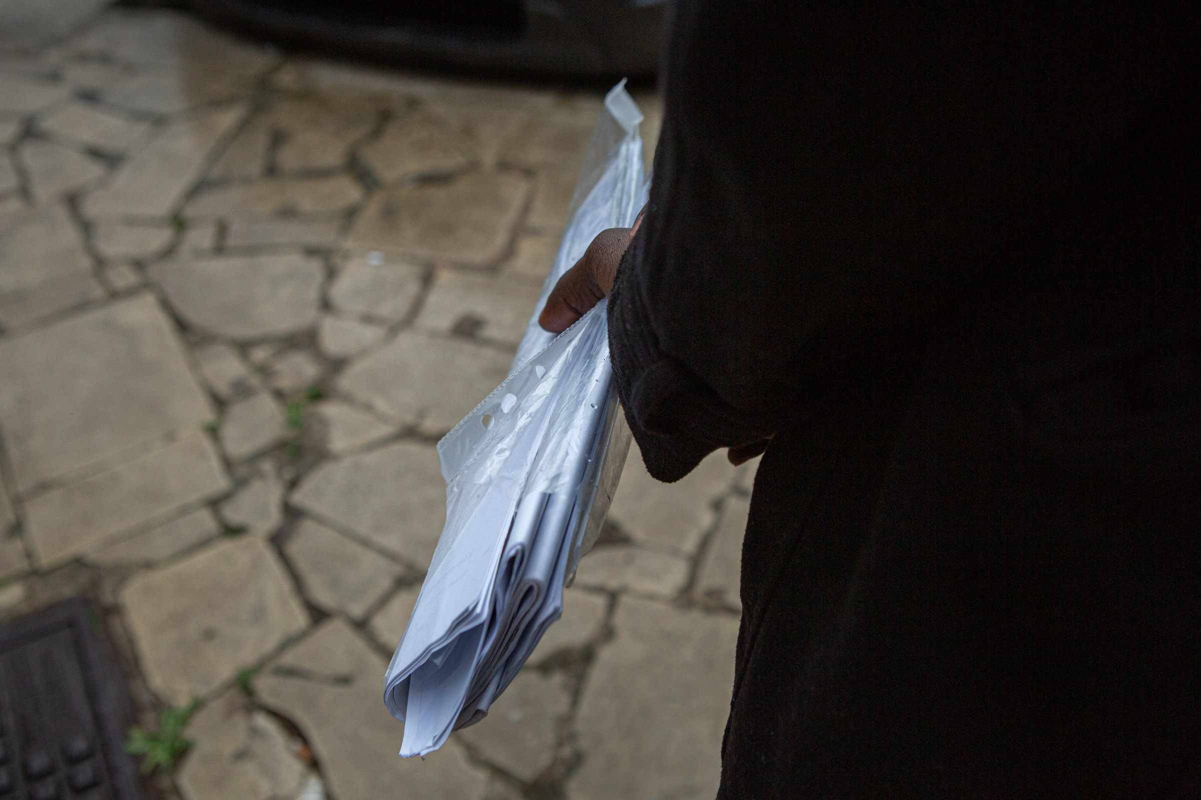 Abdirahman keeps his humanitarian protection documents and application papers in hand for his residency renewal. March 20, 2019.<br />
